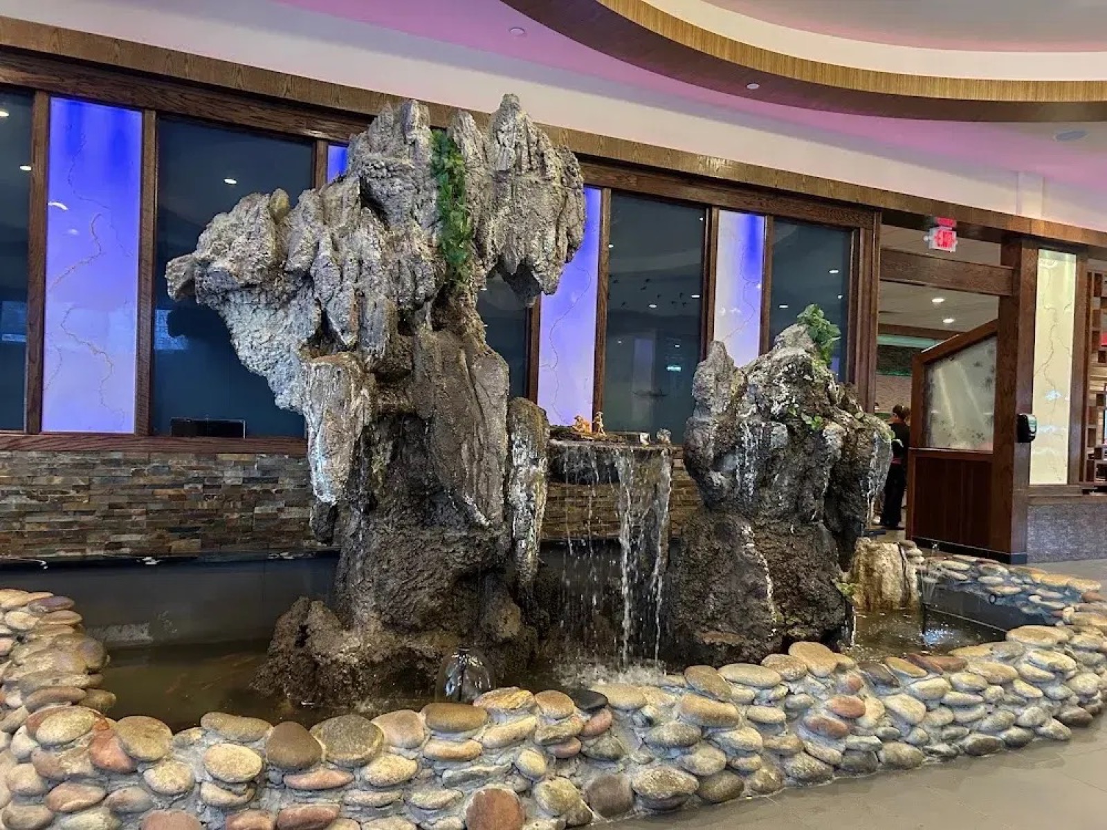 Elegant rock fountain waterfall feature in Feast Buffet lobby